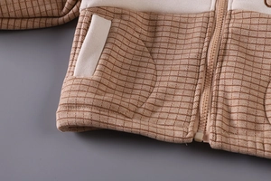 Detailed close-up of children's fleece jacket with waffle texture and zipper