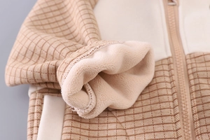 Detailed view of winter toddler jacket with warm fleece lining and plaid fabric texture