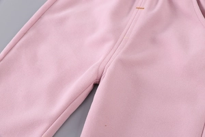 Close-up of pink cotton knit pants showing soft fabric texture and waist detail