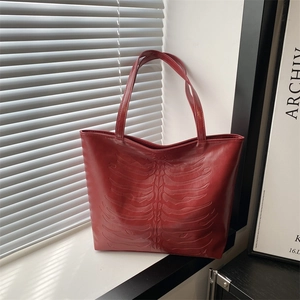 Deep red large capacity leather tote bag featuring a unique 3D bone rib pattern design