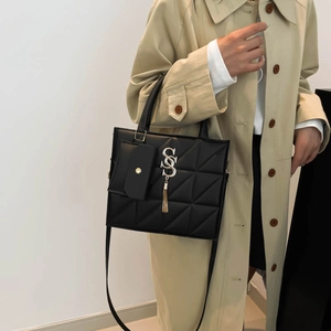 Chic black quilted tote bag with geometric stitching and detachable small pouch