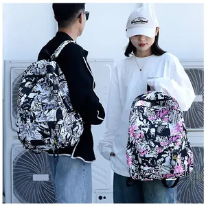 Outdoor shot of models wearing stylish graffiti-print backpacks in black and purple colors