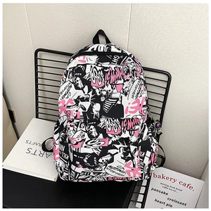 Detail of graffiti print backpack with astronaut keychain and street style design