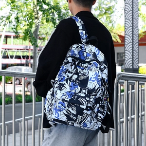 Graffiti print backpack for men featuring blue comic patterns and astronaut keychain