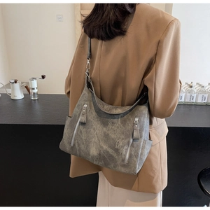Detailed side view of large vintage grey tote bag with metallic zipper and side pocket