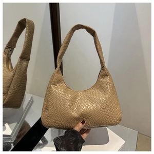 Mirror reflection showing details of beige woven crescent bag with integrated handle