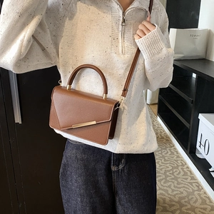 Classic brown pebble leather crossbody bag with gold hardware and top handle for women