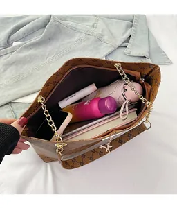 Detail showing the large interior capacity of this brown monogram tote bag for essentials