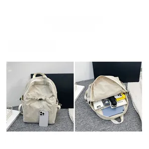 Internal view of the large capacity beige canvas backpack showing organized pockets