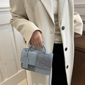 Light blue and grey patchwork square crossbody bag with handle and fashion tag