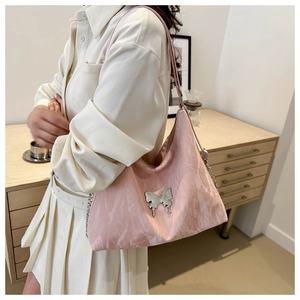 Sac à bandoulière rose avec boucle papillon argentée et texture métallisée plissée