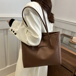 Minimalist deep brown leather tote bag with long straps for women's daily commute