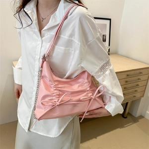 Chic pink tote bag with bow accents and silver chain strap for everyday fashion