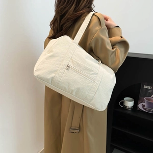 Minimalist off-white large capacity tote bag with wide shoulder strap for daily travel