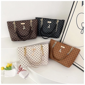 Four vintage tote bags in brown, black, cream, and caramel with geometric diamond pattern