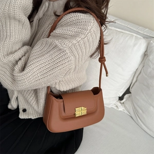 French style brown leather saddle bag with gold buckle and stylish knot strap detail