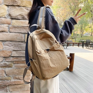 Minimalist khaki nylon backpack with drawstring closure and large storage capacity