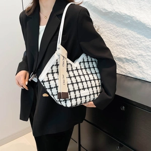 Classic black and white tweed tote bag with shoulder strap and chic woven ribbon detail