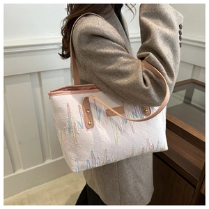 Detail of trendy tote bag featuring textured relief fabric and colorful wavy embroidery