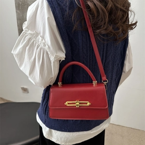 Fashionable red leather crossbody bag with gold buckle and top handle for women