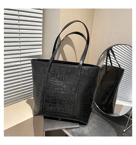 Detail of black crocodile pattern leather tote bag with large capacity and shoulder straps
