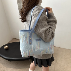 Chic light blue tote bag with colorful wavy embroidery and dual shoulder straps for women