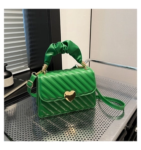 Dettaglio borsa in pelle PU verde smeraldo con fibbia a cuore e manico a nuvola