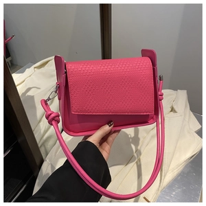 Detail of rose red woven flap shoulder bag with smooth leather and knot strap design