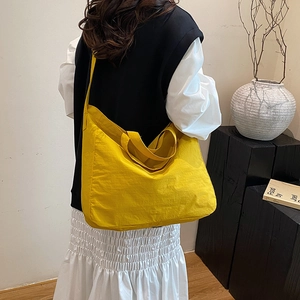 Large yellow commuter tote bag with wide shoulder straps for versatile carrying options