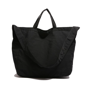 Minimalist black large capacity tote bag with dual handles and wide shoulder strap