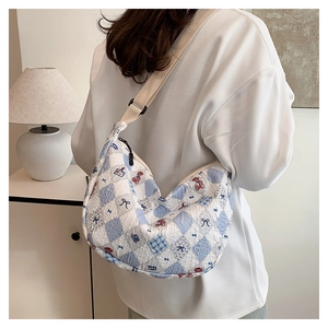 Close-up of quilted crossbody bag with cute bear prints and wide canvas shoulder strap