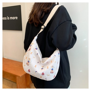 Detailed back view of a white printed crossbody bag with circus motifs and adjustable strap