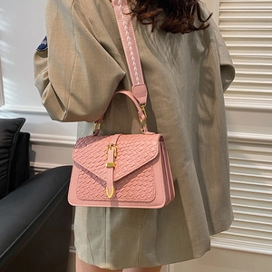 Pink woven texture leather crossbody handbag with wide shoulder strap and gold clasp
