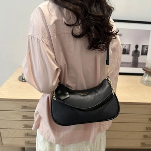 Chic black crescent shoulder bag with lychee texture leather and gold chain detail