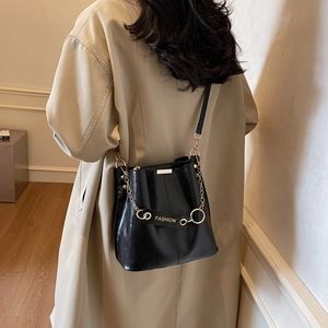 Retro black leather bucket bag with gold chain and fashion strap shown on model back