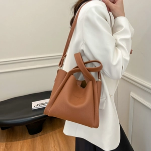 Brown lychee texture leather bucket bag with top handles and adjustable strap