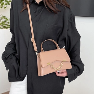 Minimalist structured shoulder bag in apricot faux leather with gold chain and top handle