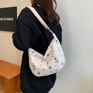 Quilted white hobo bag with circus prints and wide shoulder strap for casual wear