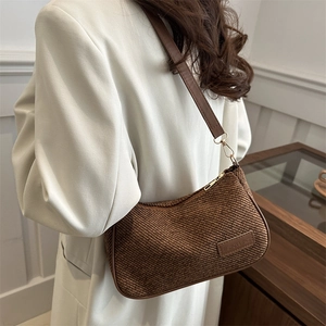 Brown woven crescent shoulder bag with fashion leather tag and elegant metal zipper