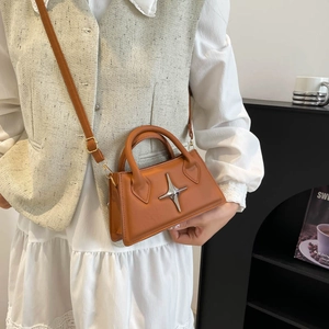 Minimalist orange-brown shoulder bag with silver star metal accent and y2k retro style