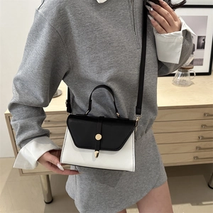 Minimalist black and white colorblock crossbody bag with golden round clasp for women