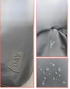 Waterproof detail of gray nylon backpack fabric featuring stitched DAY leather patch