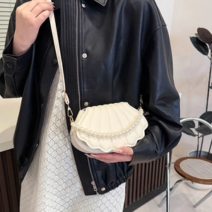 Minimalist shell-shaped crossbody bag with pearl strap and textured PU leather finish