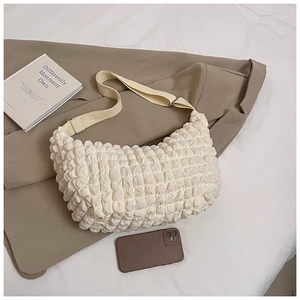 Detailed view of the white popcorn texture fabric on this minimalist hobo shoulder bag