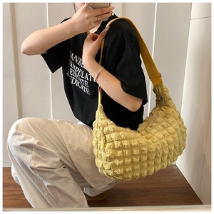 Detail of ginger yellow popcorn texture shoulder bag with soft 3D puffy fabric surface