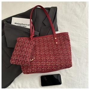 Detail of red tweed tote bag set with gold thread accents and matching zipper pouch