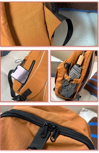 Detail view of mustard yellow backpack featuring side phone pocket and umbrella mesh pouch