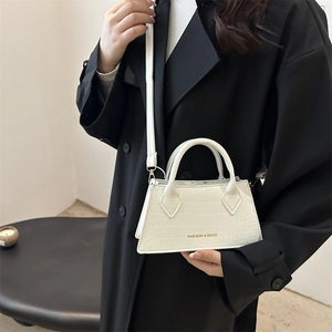 White crocodile pattern top handle crossbody bag featuring gold lettering and long strap
