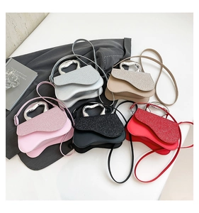 Detail view of mini shoulder bags in five colors with sequin finish and heart metal handles