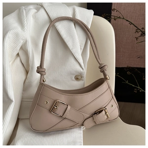 Chic beige leather baguette bag with metal buckle detail and knot shoulder strap
